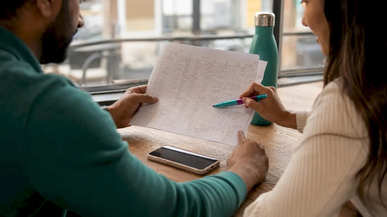 Hands preparing prospecting lists collaboratively